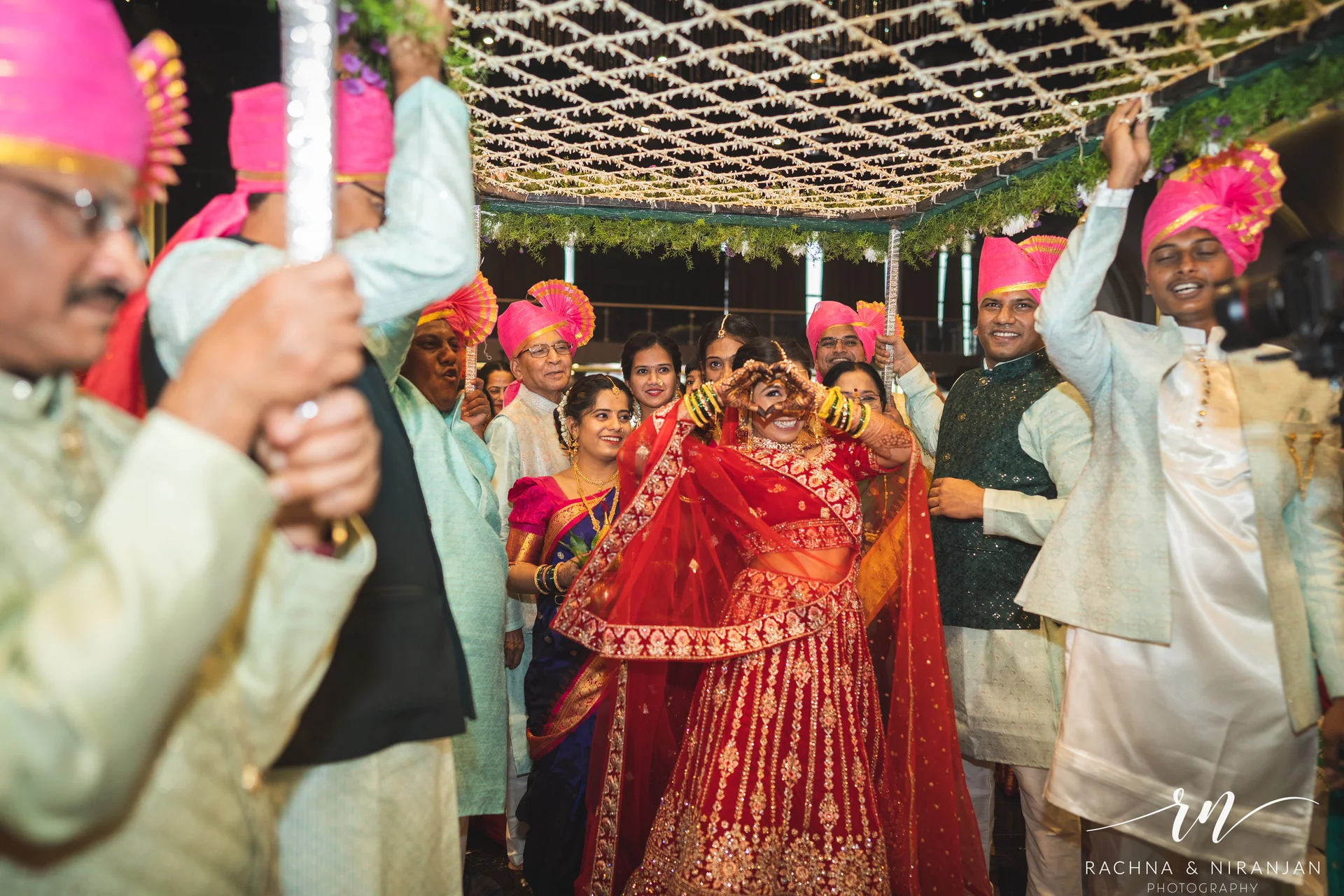 Gujarati bride Sneha walking down the aisle during her bridal entry at Mayfield Estate – beautifully documented by candid wedding photographers in Pune