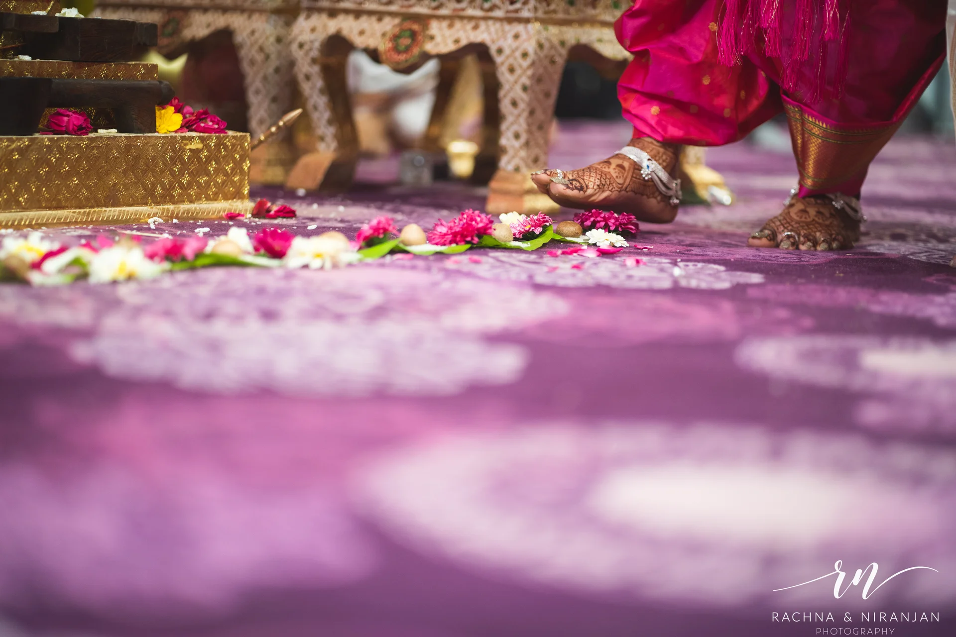 Bride and groom participating in Gujarati wedding customs with family at Mayfield Estate, Pune