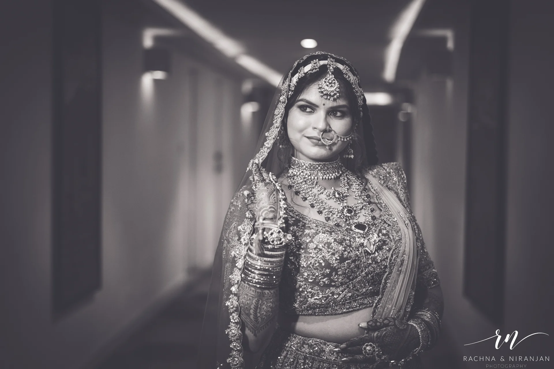 Emotional black and white photo of bride Pratiksha reflecting before her pheras – a quiet moment at her Amanora The Fern wedding