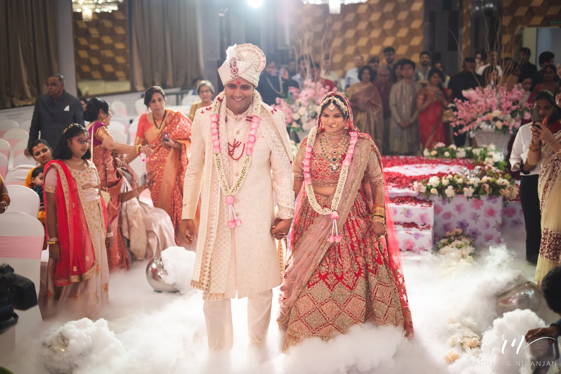 Traditional bridal entry of Pratiksha surrounded by family and friends at Amanora The Fern – classic Bihari wedding photography
