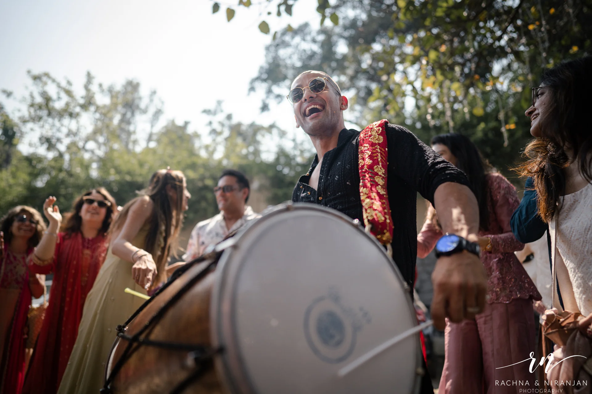 Friends and family dancing at destination wedding sangeet