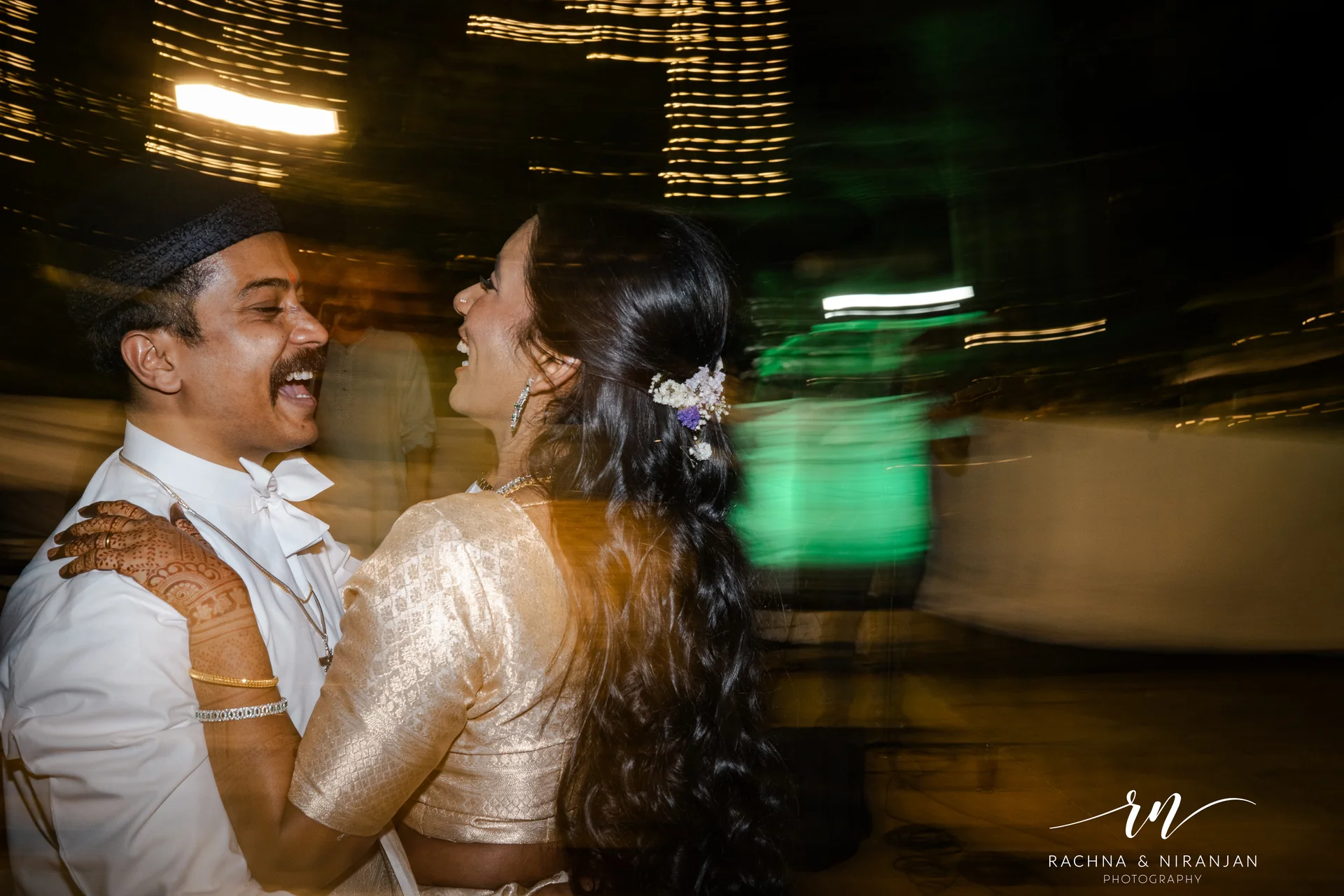 Couple at lit reception venue Turf Club Pune — wedding photography Pune